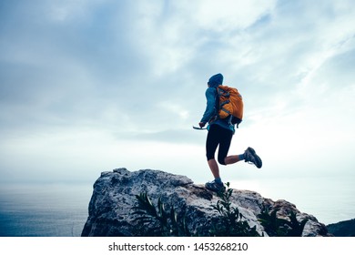 Successful Woman Hiker Running To On Seaside Mountain Peak Cliff Edge