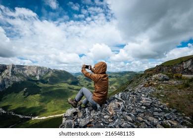 Successful Woman Hiker Using Smart Phone On Alpine Mountain Top