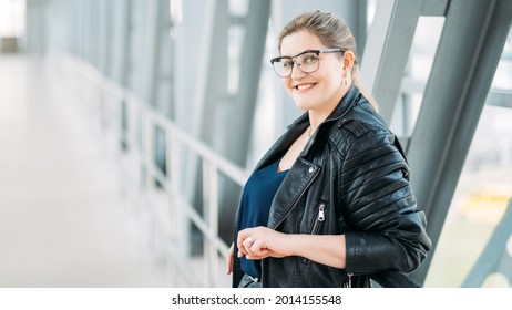 Successful woman lifestyle. Body positive. Female freedom. Urban style. Confident happy satisfied smiling overweight plus size obese model in leather jacket alone on bridge. - Powered by Shutterstock