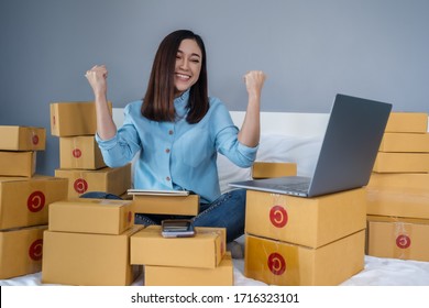 Successful Woman Working And Using Laptop Computer To Selling Product Online On A Bed At Home