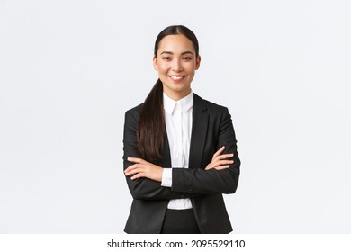 Successful young asian businesswoman in suit ready do business, cross arms confident and smiling. Female entrepreneur determined to win. Happy saleswoman talking to clients, white background - Shutterstock ID 2095529110