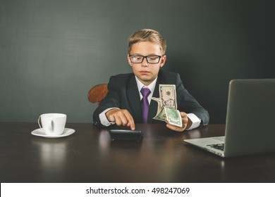 Successful Young Banker Boy Holding Money. US Dollar. American Ollars. Do You Have A Bank Account? Uses Laptop