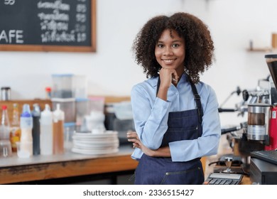 Successful young baristas woman standing in bar counter in cafe. Small startup business owner concept. Happy coffee shop woman waitress in an apron smiling confidently in a cafe. - Powered by Shutterstock