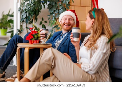 Successful Young Business People Having Fun Celebrating Christmas At The Office, Wearing Costume Reindeer Antlers And Santa Hat, Taking A Coffee Break And Relaxing