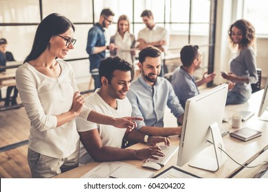 Successful Young Business People Are Using A Computer And Smiling While Working In Business Center