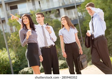 Successful Young Business Team During A Coffee Break, Walking On A Park And Enjoying A Sunny Day.