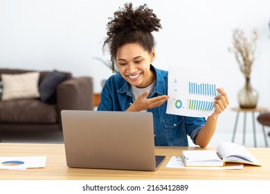 Successful Young Business Woman CEO Communicates With Employees Online Using Laptop. African American Woman Showing Sales Report. Online Meeting