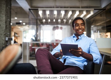 Successful young businessman using a tablet in a modern office