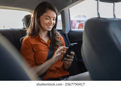 Successful young businesswoman in office clothes working using smart phone in sitting back seat of car in urban modern city in night. People occupational burnout syndrome concept. - Powered by Shutterstock