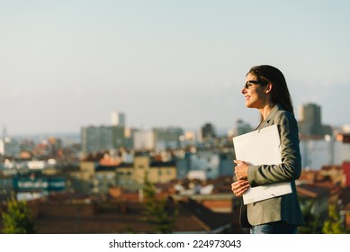 Successful Young Businesswoman Towards City Background. Professional Happy Woman Walking Outside.