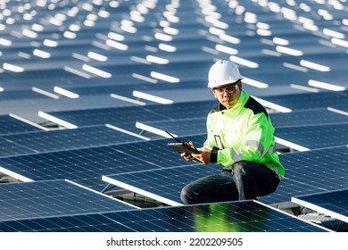 Successful Young Engineer In Uniform  Checks The Productivity Solar Panel Field For Examination