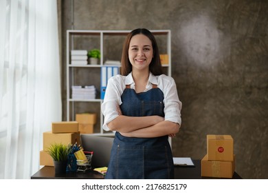 Successful young owner business woman is standing and cross one's arm with proud of her success in office space.