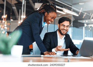 Successful young people working in a coworking space. African American Woman With Her Team Working With Laptop Discussing Strategy And Business Plan In Modern Office. - Powered by Shutterstock