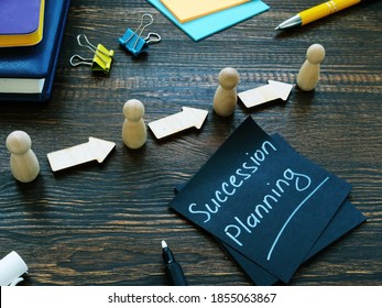Succession planning sign and figurines with arrows.