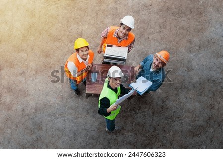 Succsess teamwork. Construction workers smile happily after meeting and disscussion in new project with blueprint planning in house,  in real estage, property or architecture inovation. 