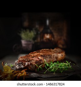 Succulent Farmhouse Rustic Rump Steak with thyme garnish shot against a dark background with wood burner. The perfect image for your bistro or restaurant menu cover art. Copy space. - Shutterstock ID 1486317824