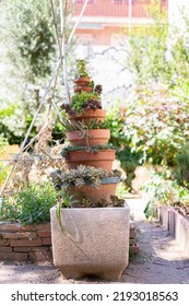 Succulent Plant Tower Made Of Stacked Ceramic Pots And Large White Gray Stone Potter