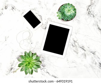 Succulent plants, tablet PC, phone on marble background. Office table. Flat lay mock up for social media blog