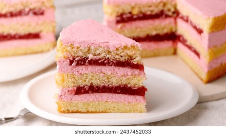 Succulent strawberry cake on display, featuring soft sponge layers filled with vibrant strawberry cream and a luscious jam, perfectly cut to showcase its moist texture and inviting pink hues - Powered by Shutterstock