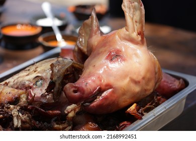 a suckling pig or pig roasted on a spit or in the oven lies on a tray