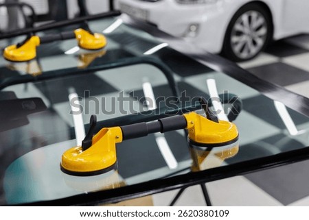 Suction pads for car windshield installing in workshop