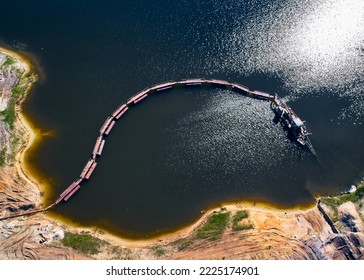 Suction Tube Dredger In Sand Pit Full Of Water On Sunny Day