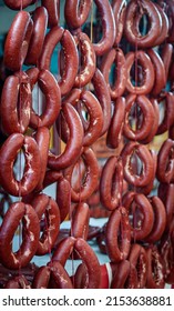 Sucuk, A Fermented Spicy Turkish Sausage Made With Ground Beef, Spices And Animal Fat Hanging In Rows At A Regional Food Market; Traditionally Cooked For Breakfast With Eggs