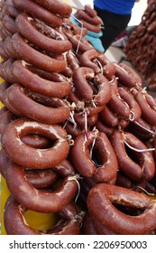 Sucuk, A Fermented Spicy Turkish Sausage Made With Ground Beef, Spices And Animal Fat Hanging In Rows At A Regional Food Market; Traditionally Cooked For Breakfast With Eggs