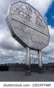 Sudbury, Ontario, Canada -2022: Big Nickel - Giant Replica Of A 1951 Canadian Nickel At Dynamic Earth Science Museum. Canadian Nickel Refinery Chimney Or Superstack. 
