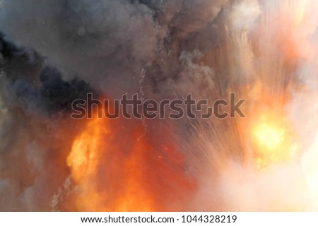 Sudden massive explosion of the bomb. The blast wave. The volumes of black smoke and sparks of fire. Detonation of the bomb or cannon ball. Outburst close up. 
