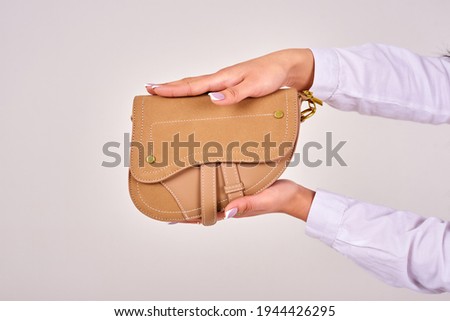 suede women's bag in women's hands