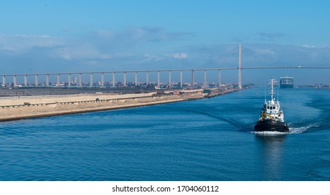 Suez Canal, Egypt. January 23 2020: A container ship approaches the Mubarak Peace Bridge.