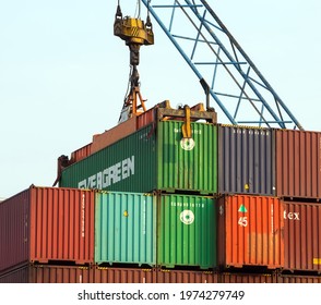 Suez Canal, Egypt - March 29, 2021: Container Cargo Cranes Unloading Of Containers In The Evergreen Ship