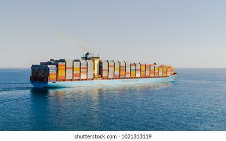 Suez Canal, Egypt-November 5, 2017: Maersk line cargo vessel container ship passing Suez Canal, sun set. GEORG MAERSK is registered and sailing under flag of Denmark, her gross tonnage -98648 