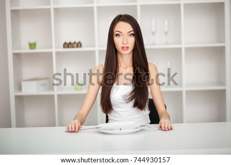 Suffering from anorexia. Image of girl trying to put a pea on the fork