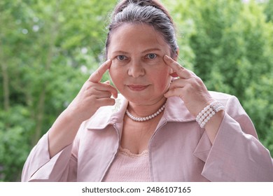 Suffering mature woman with migraine headache clutches head in pain, health awareness, medical attention, headache suffering, migraine relief, health crisis - Powered by Shutterstock