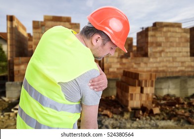 Constructor suffering from shoulder pain or having an accident on outdoor construction workplace