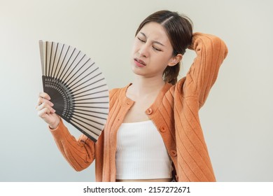 Suffering Summer Heat Stroke, Hot Weather, Tired Asian Young Woman, Girl Sweaty And Thirsty, Refreshing With Hand In Blowing, Wave Fan To Ventilation When Temperature High At Home, House.on Background