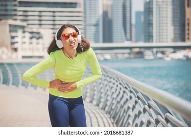 Suffering Woman On A Jog Is Experiencing Severe Pain In Her Side. Fitness And Sports Exercises During Diseases Of The Liver, Spleen And Stomach Ulcer