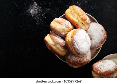 Sufganiyot donuts with jelly on black background