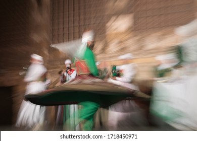 Sufi religious dancers,Twirling Dervishes, performing in open air courtyard. Cairo, El Ghuri Market. Egypt.