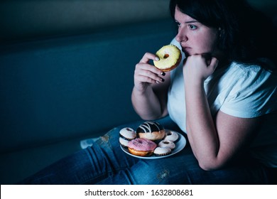 Sugar Addiction, Unhealthy Lifestyle, Weight Gain, Dietary, Healthcare And Medical Concept. Cropped Portrait Of Overweight Depressed Woman Laying On Sofa Eating Sugary Food Watching TV