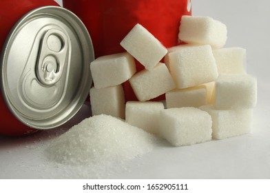 Sugar Adiction: Close Up Of Red Soda Softdrink Cans And Sugar  