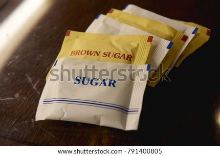 Sugar and brownsugar packets on the table           