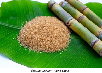 Sugar cane with brown sugar on banana leaf