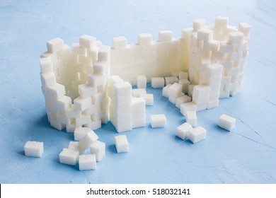 Sugar Castle Built Out Of Sugar Cubes, Sugar Tower, Sugar Walls, Blue Background, Ruins, Broken