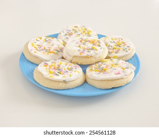 Sugar Cookies With Frosting On Blue Plate.