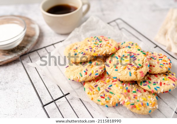 Sugar cookies with sprinkles, colorful\
coffee treat. freshly baked dessert\
cookies.