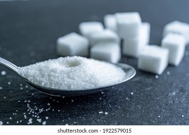 Sugar Cubes On Black Backround. Sugar Is Unhealthy Nutrition And Leads To Obesity, Diabetes, Dental Care