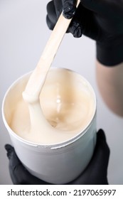 Sugar Depilation. Sugar Paste Dripping From A Wooden Spatula Into A Jar